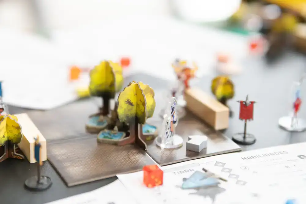 Players moving miniatures on a large game board