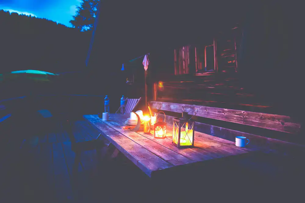 Dice, character sheets, and a warm lantern on a wooden tavern table