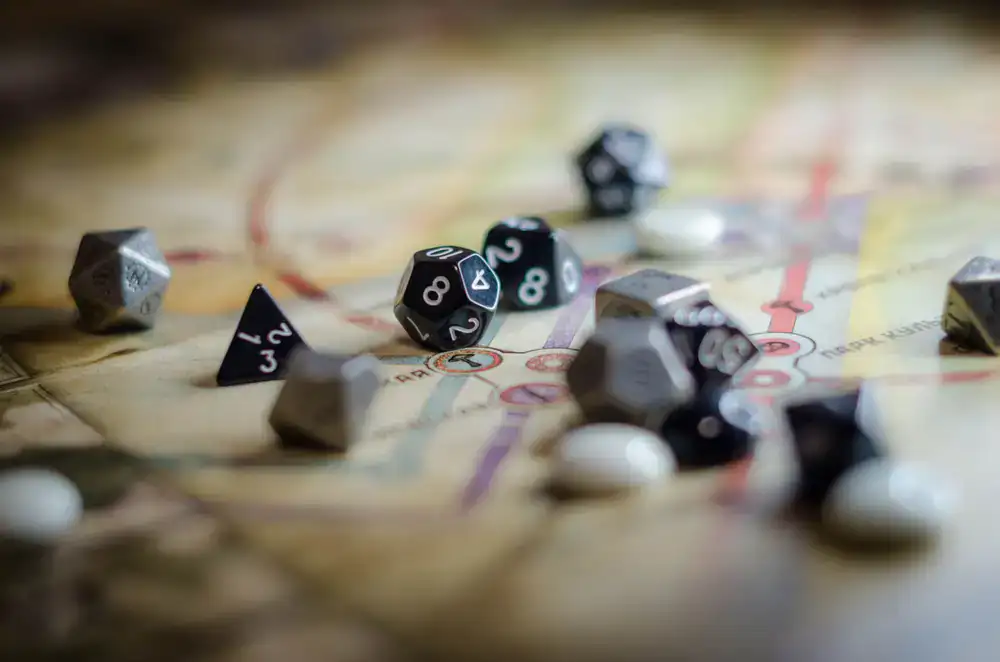 Assorted roleplaying dice and rulebooks on a wooden table