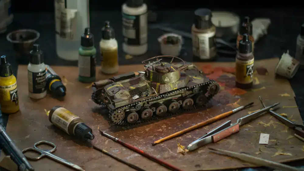 Detailed unpainted miniatures and paints on a workstation