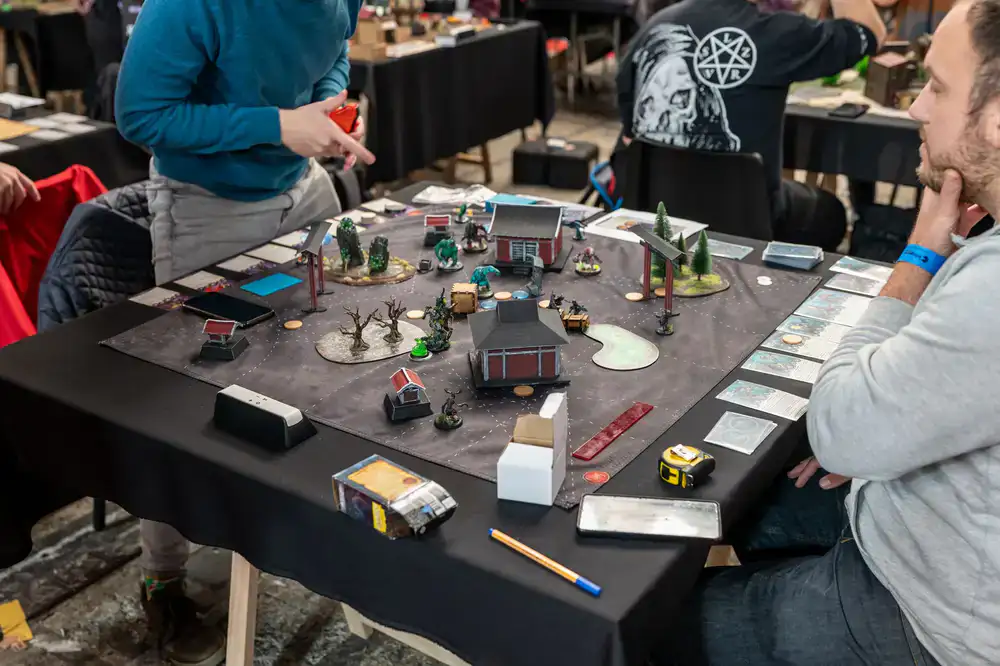 Players sitting around a warm tavern-lit game table